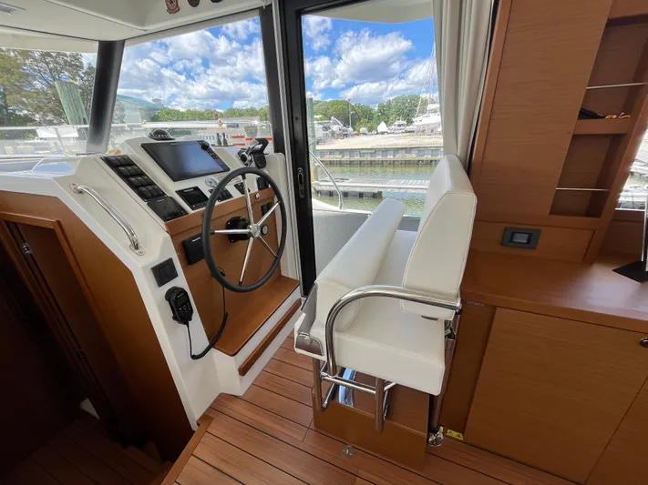 Yacht Photos Pics 2023 Beneteau Swift Trawler 41 Fly helm station with modern controls and comfortable seating.