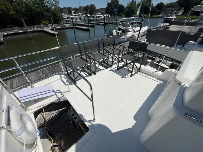  Yacht Photos Pics Flybridge of 2023 Beneteau Swift Trawler 41 Fly with seating, overlooking marina.
