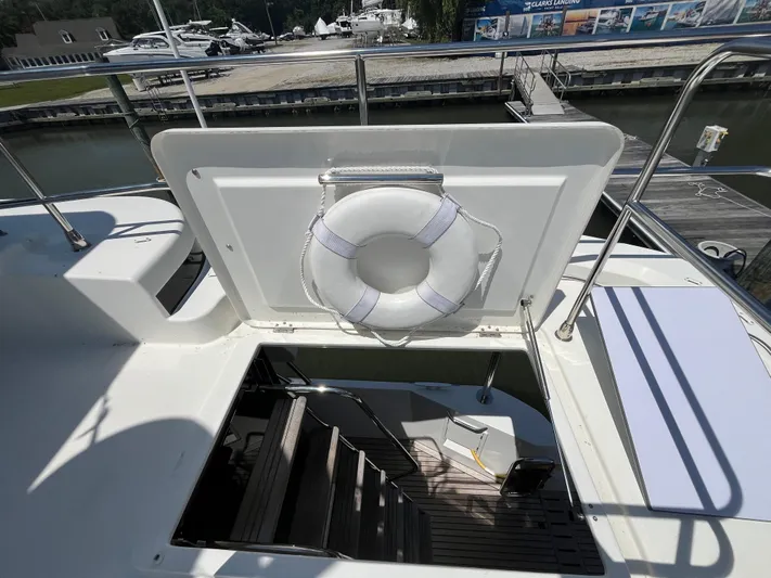  Yacht Photos Pics 2023 Beneteau Swift Trawler 41 Fly, open hatch with life preserver, dockside view.