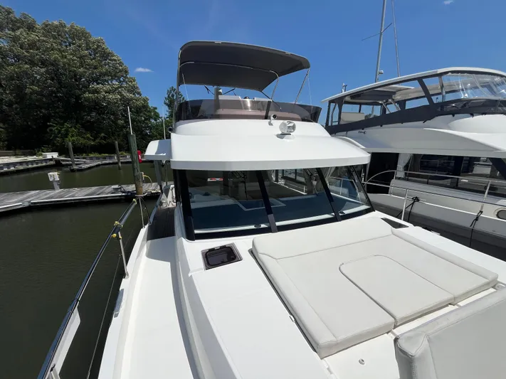  Yacht Photos Pics 2023 Beneteau Swift Trawler 41 Fly docked, showcasing sleek design and spacious deck.