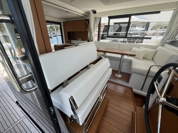  Yacht Photos Pics Interior of 2023 Beneteau Swift Trawler 41 Fly with modern seating and steering area.