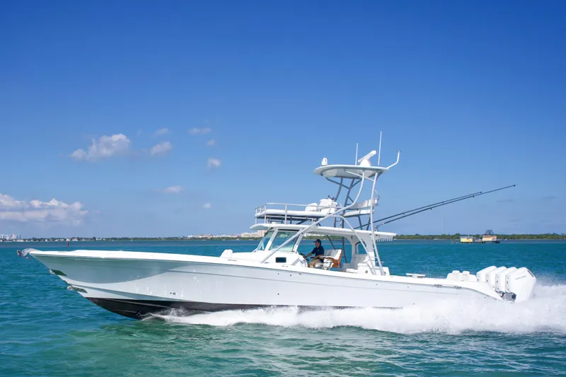  Yacht Photos Pics 2023 HCB 53 Sue&ntilde;os boat cruising on clear blue water under a sunny sky.