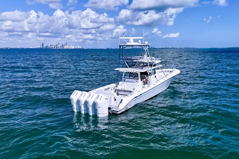  Yacht Photos Pics 2023 HCB 53 Sue&ntilde;os boat on open sea with city skyline in background.