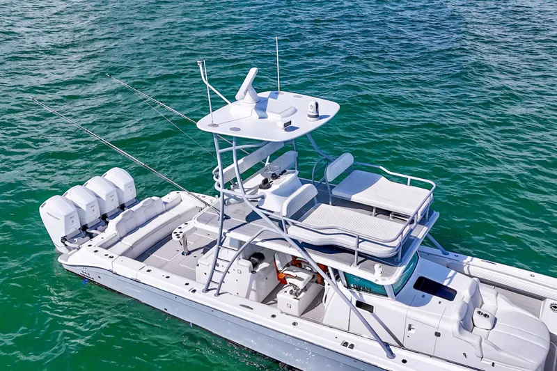  Yacht Photos Pics 2023 HCB 53 Sue&ntilde;os boat on water, featuring multiple outboard engines.