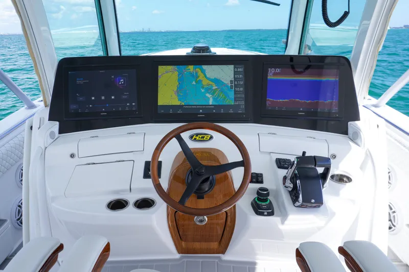  Yacht Photos Pics Helm of 2023 HCB 53 Sue&ntilde;os boat with advanced navigation displays and controls.