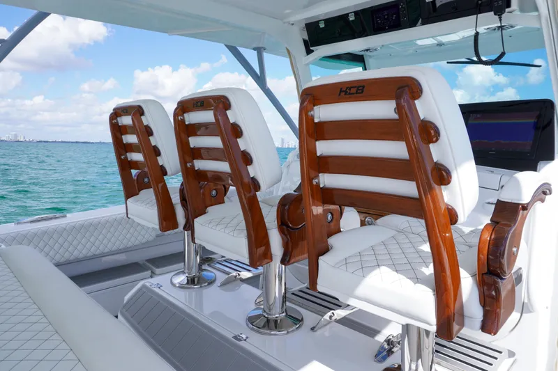  Yacht Photos Pics Luxury seating on 2023 HCB 53 Sue&ntilde;os boat, featuring elegant wood and white upholstery.