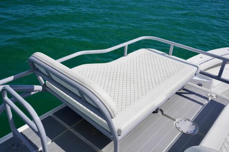  Yacht Photos Pics Luxury seating on 2023 HCB 53 Sue&ntilde;os boat, overlooking clear blue water.