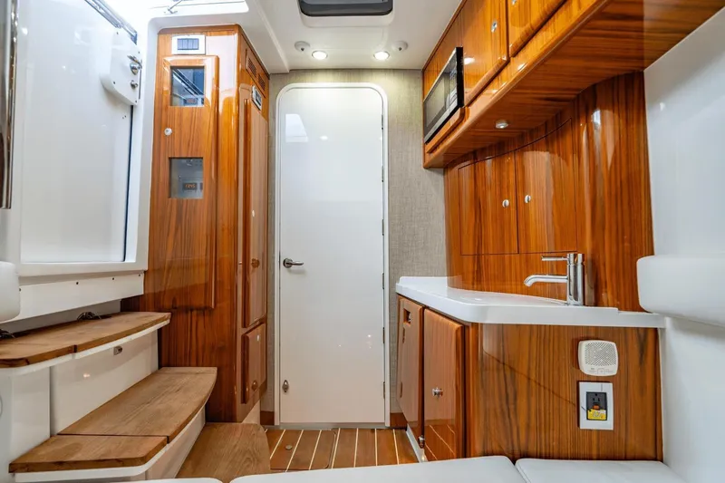  Yacht Photos Pics Luxurious interior of 2023 HCB 53 Sue&ntilde;os boat with wood finishes and modern amenities.