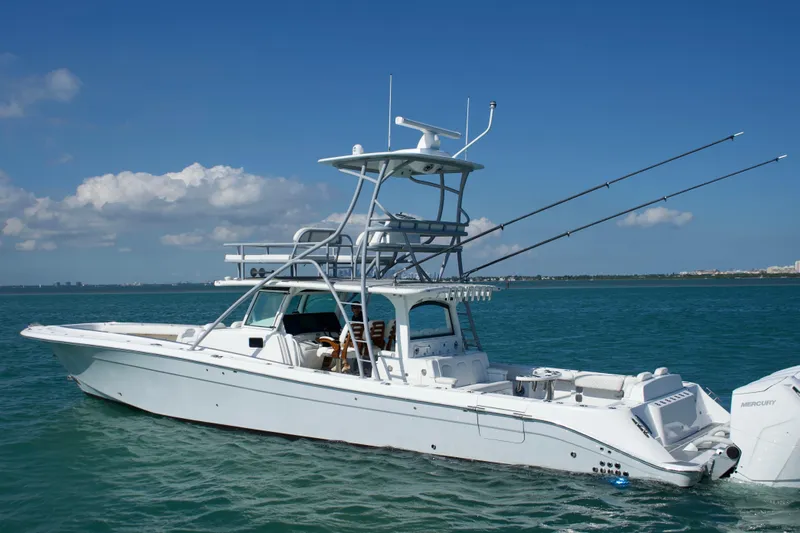  Yacht Photos Pics 2024 HCB 53 Sueños boat on calm ocean waters under clear blue sky.
