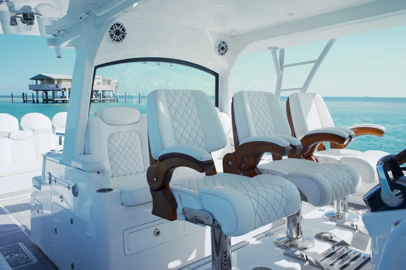  Yacht Photos Pics Luxurious seating on the 2024 HCB 53 Sueños yacht, overlooking serene ocean waters.