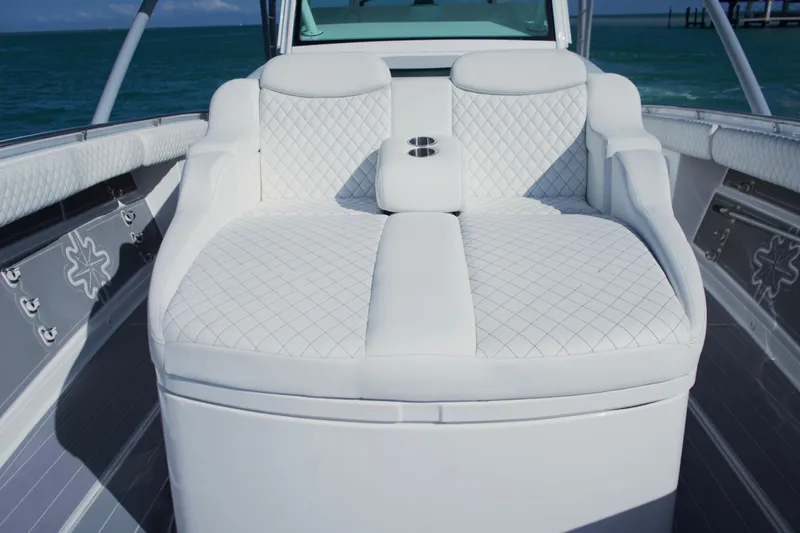  Yacht Photos Pics Luxurious seating on 2024 HCB 53 Sueños boat, featuring white quilted upholstery.