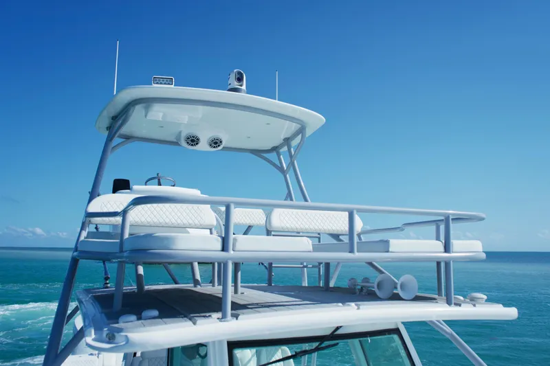  Yacht Photos Pics 2024 HCB 53 Sueños yacht, upper deck view, cruising on clear blue ocean.