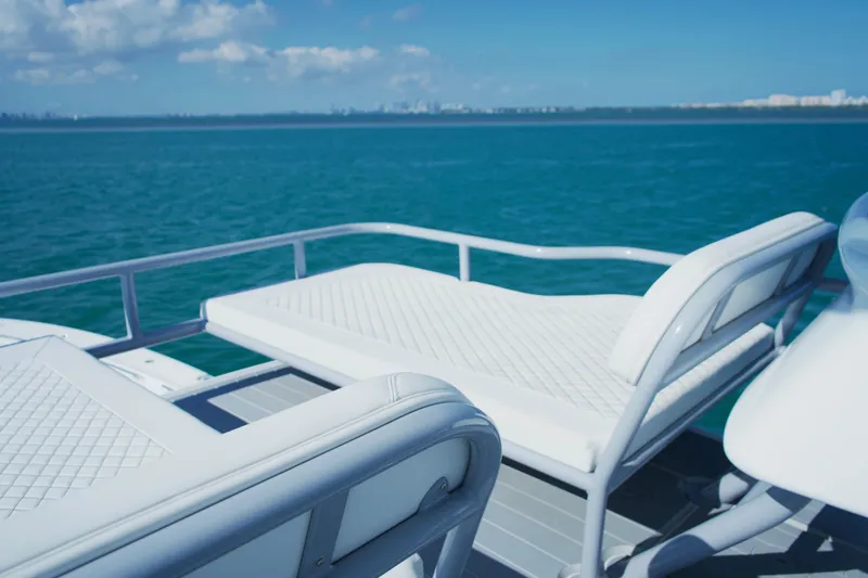  Yacht Photos Pics Luxury seating on 2024 HCB 53 Sueños yacht, overlooking serene ocean waters.