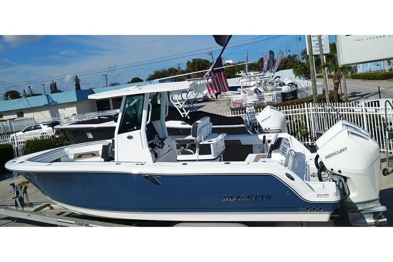 252-449 Yacht Photos Pics 2025 Blackfin 252 CC boat with dual Mercury engines, docked outdoors.