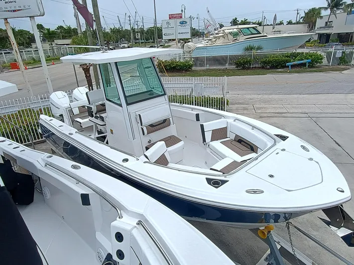 252-449 Yacht Photos Pics 2025 Blackfin 252 CC boat displayed at a marina, showcasing sleek design and modern features.