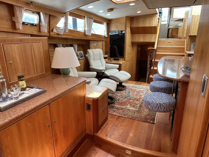 Alacrity Yacht Photos Pics Luxurious interior of 2008 Lyman-Morse Flybridge 62' yacht with wood finishes and seating area.