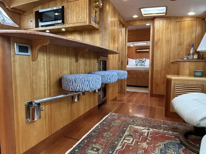 Alacrity Yacht Photos Pics Interior of 2008 Lyman-Morse Flybridge 62' yacht with wooden cabinetry and seating.