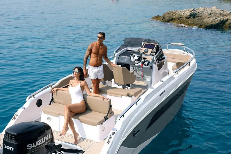  Yacht Photos Pics 2025 Ranieri 275 LS boat with two people relaxing on deck in clear blue water.