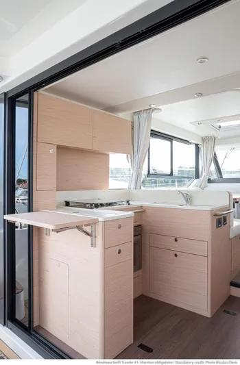 In Stock Yacht Photos Pics 2024 Beneteau Swift Trawler 41 Sedan interior with modern kitchen and sleek design.