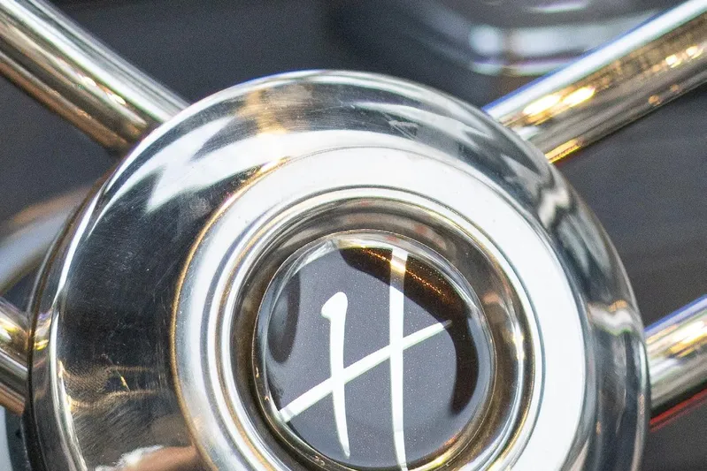  Yacht Photos Pics Close-up of 2024 Hanover 347 White & Black Edition steering wheel emblem.