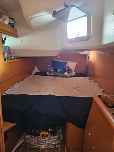 Helix Yacht Photos Pics Cozy cabin interior of 2011 Jeanneau 44i sailboat with bed and porthole.