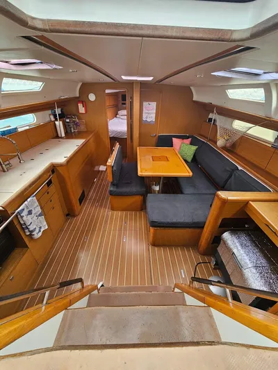 Helix Yacht Photos Pics Interior of 2011 Jeanneau 44i sailboat with spacious seating and wooden finishes.