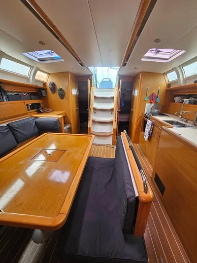 Helix Yacht Photos Pics Interior of 2011 Jeanneau 44i sailboat with dining area and kitchen.