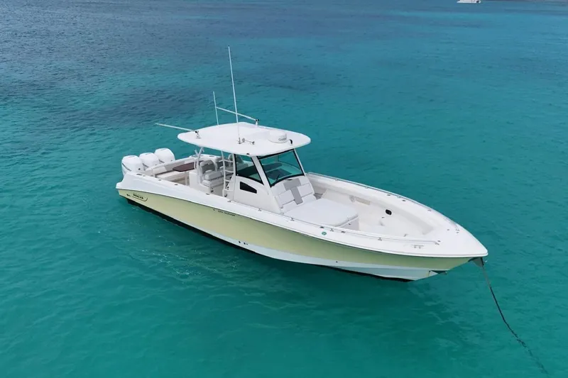  Yacht Photos Pics 2010 Boston Whaler 370 Outrage boat anchored in clear turquoise water.