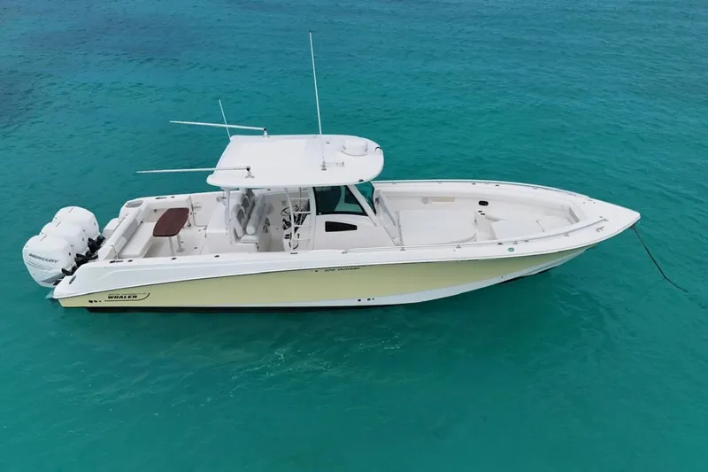  Yacht Photos Pics 2010 Boston Whaler 370 Outrage boat on clear turquoise water.