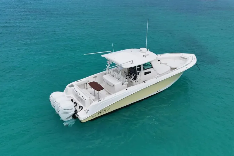  Yacht Photos Pics 2010 Boston Whaler 370 Outrage boat on clear turquoise water.