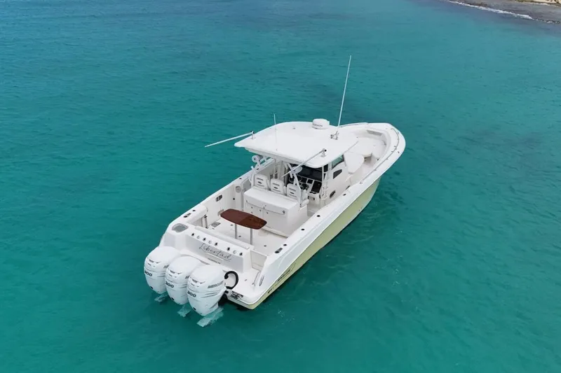  Yacht Photos Pics 2010 Boston Whaler 370 Outrage boat on clear turquoise water.