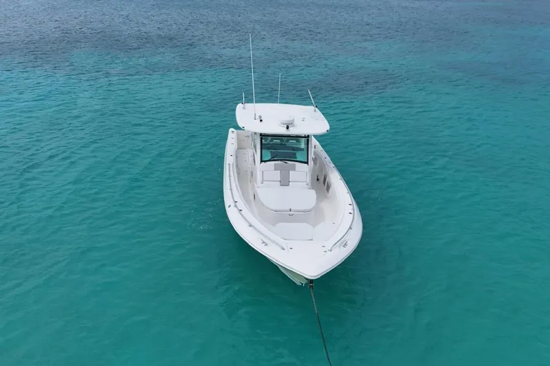  Yacht Photos Pics Boston Whaler 370 Outrage 2010 boat anchored in clear turquoise water.