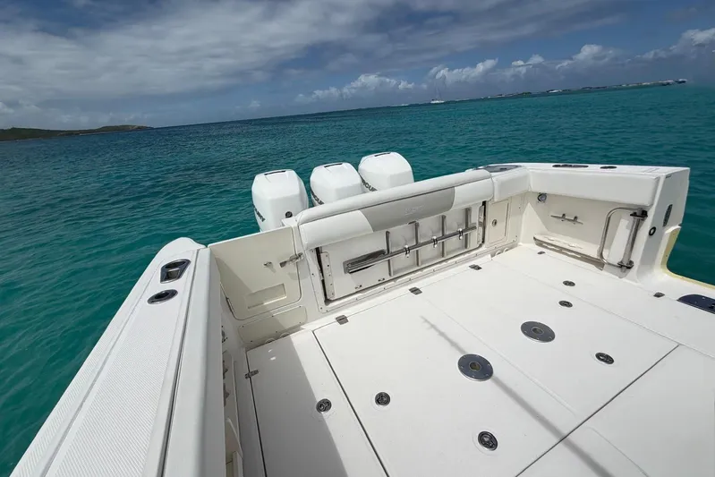  Yacht Photos Pics Boston Whaler 370 Outrage 2010 boat deck with triple engines on turquoise water.