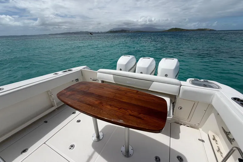  Yacht Photos Pics Boston Whaler 370 Outrage 2010 boat with wooden table, ocean view, and triple engines.