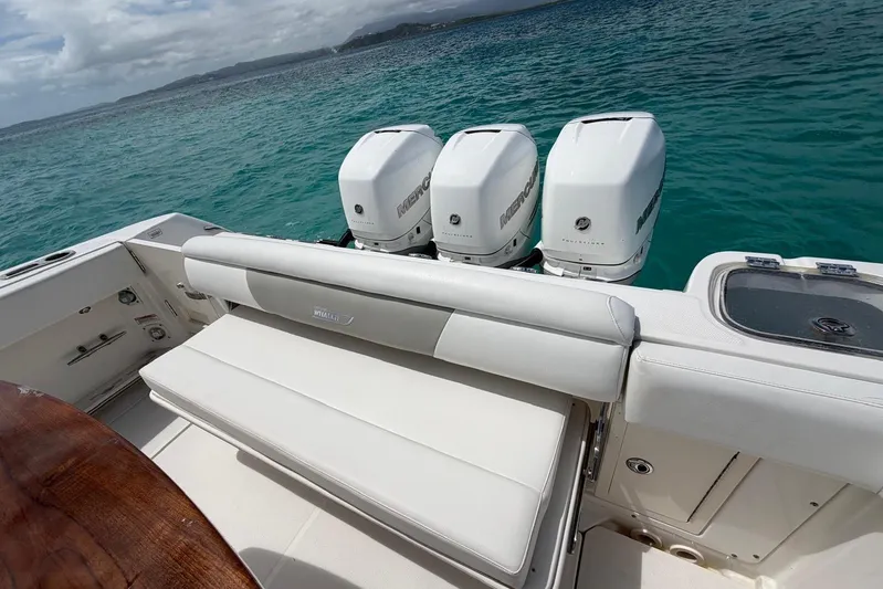  Yacht Photos Pics 2010 Boston Whaler 370 Outrage boat with triple Mercury engines on turquoise water.