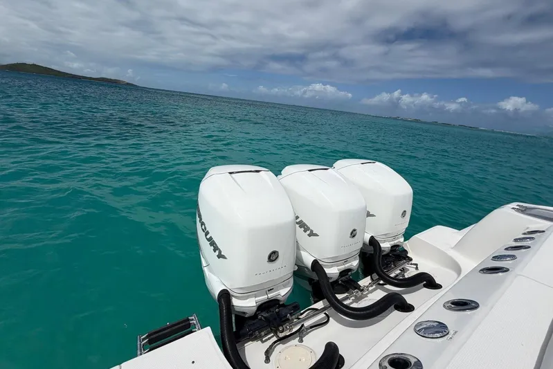  Yacht Photos Pics Boston Whaler 370 Outrage 2010 with triple Mercury outboard engines on turquoise sea.