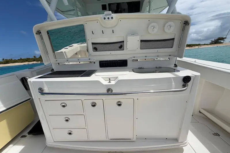  Yacht Photos Pics 2010 Boston Whaler 370 Outrage boat with onboard kitchenette, featuring storage and sink.