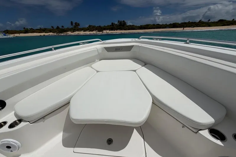  Yacht Photos Pics 2010 Boston Whaler 370 Outrage boat with cushioned seating, ocean view, and clear sky.