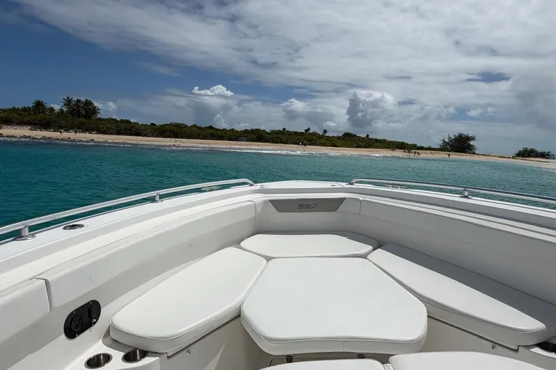  Yacht Photos Pics Boston Whaler 370 Outrage 2010 boat near tropical beach with clear blue water.