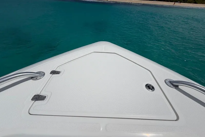  Yacht Photos Pics Bow of 2010 Boston Whaler 370 Outrage on clear turquoise water.