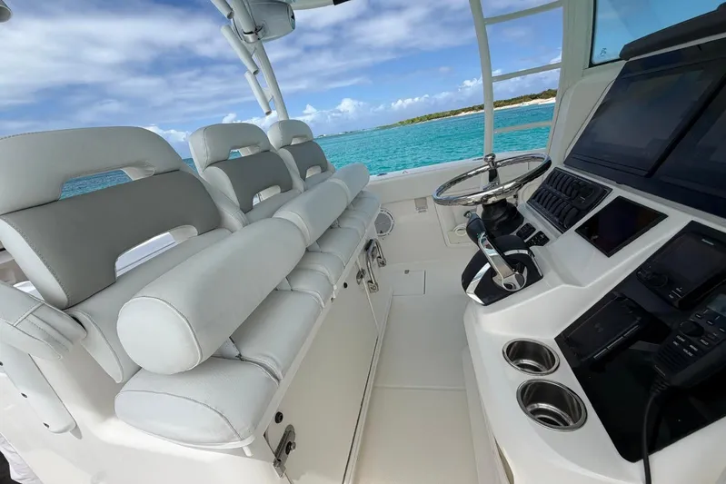  Yacht Photos Pics Interior of 2010 Boston Whaler 370 Outrage boat with helm and seating, ocean view.