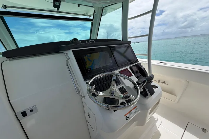  Yacht Photos Pics Boston Whaler 370 Outrage 2010 helm with modern controls and ocean view.