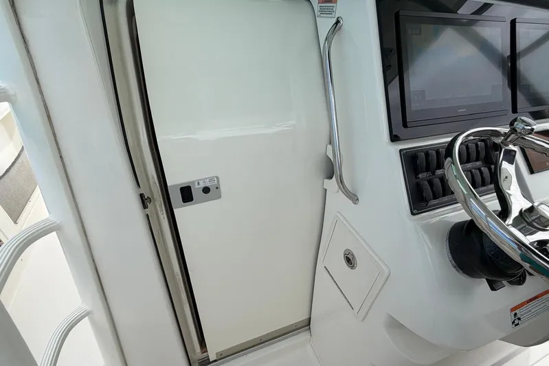  Yacht Photos Pics 2010 Boston Whaler 370 Outrage helm with steering wheel and control panel.