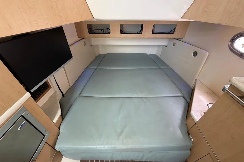  Yacht Photos Pics Interior cabin of 2010 Boston Whaler 370 Outrage with bed and TV.