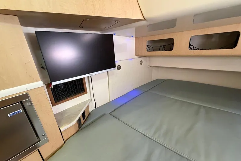  Yacht Photos Pics Interior cabin of 2010 Boston Whaler 370 Outrage with TV and comfortable seating.