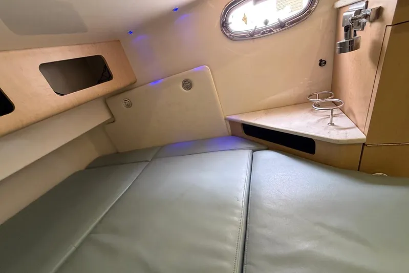  Yacht Photos Pics Interior cabin of 2010 Boston Whaler 370 Outrage with cushioned seating and porthole.