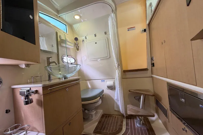  Yacht Photos Pics Interior of 2010 Boston Whaler 370 Outrage boat, featuring modern bathroom amenities.