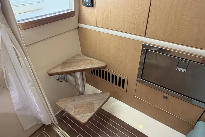  Yacht Photos Pics Interior of a 2010 Boston Whaler 370 Outrage, featuring wooden steps and cabinetry.