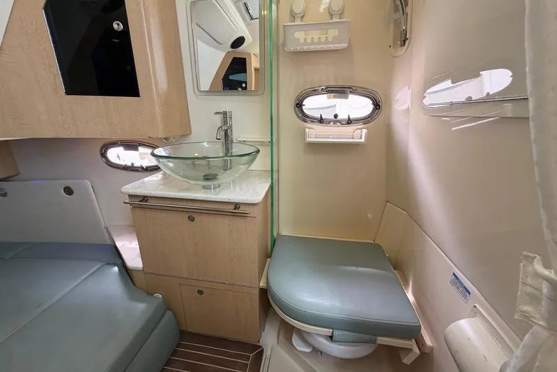  Yacht Photos Pics Interior of 2010 Boston Whaler 370 Outrage, featuring a modern bathroom with glass sink.