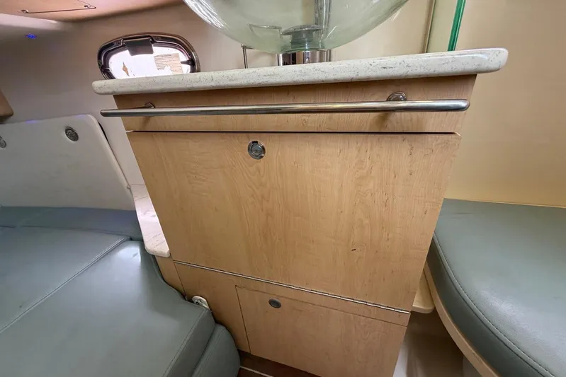  Yacht Photos Pics Interior of a 2010 Boston Whaler 370 Outrage, featuring a wooden cabinet and seating.